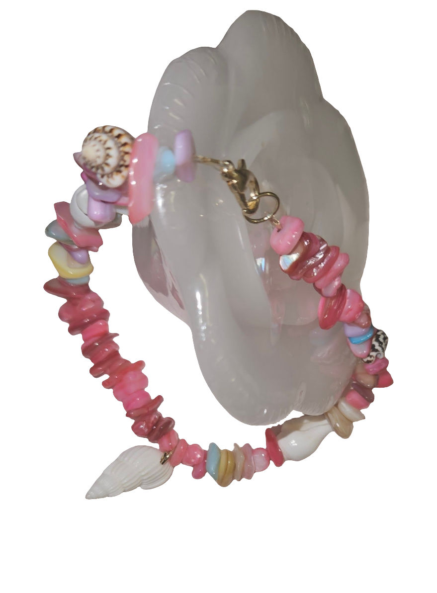 Colorful beaded bracelet with a shell on a white background