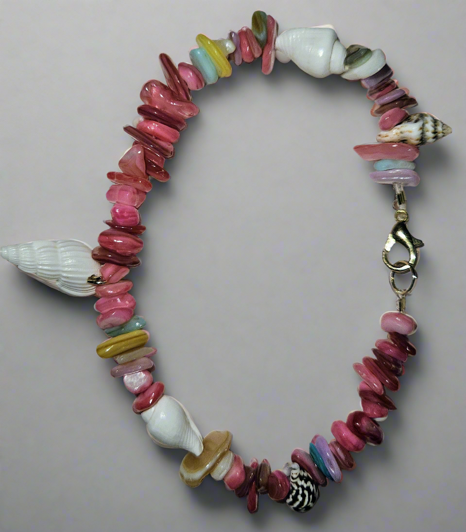 Colorful beaded bracelet with shell elements on a light gray background