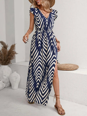 Model wearing the Printed V-Neck Cap Sleeve Maxi Dress, styled with minimal accessories for an effortless chic look
