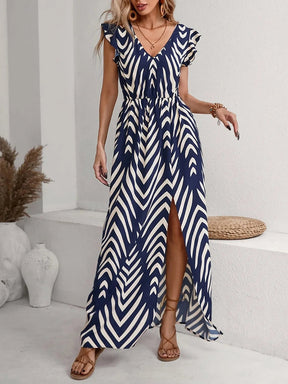 Model wearing the Printed V-Neck Cap Sleeve Maxi Dress, styled with minimal accessories for an effortless chic look.

