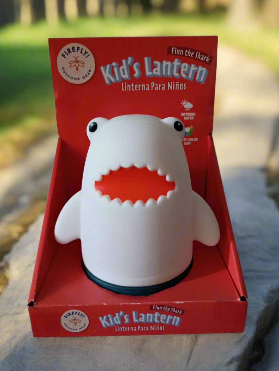 Shark-shaped kids' lantern in a red box with 'Firefly' branding.