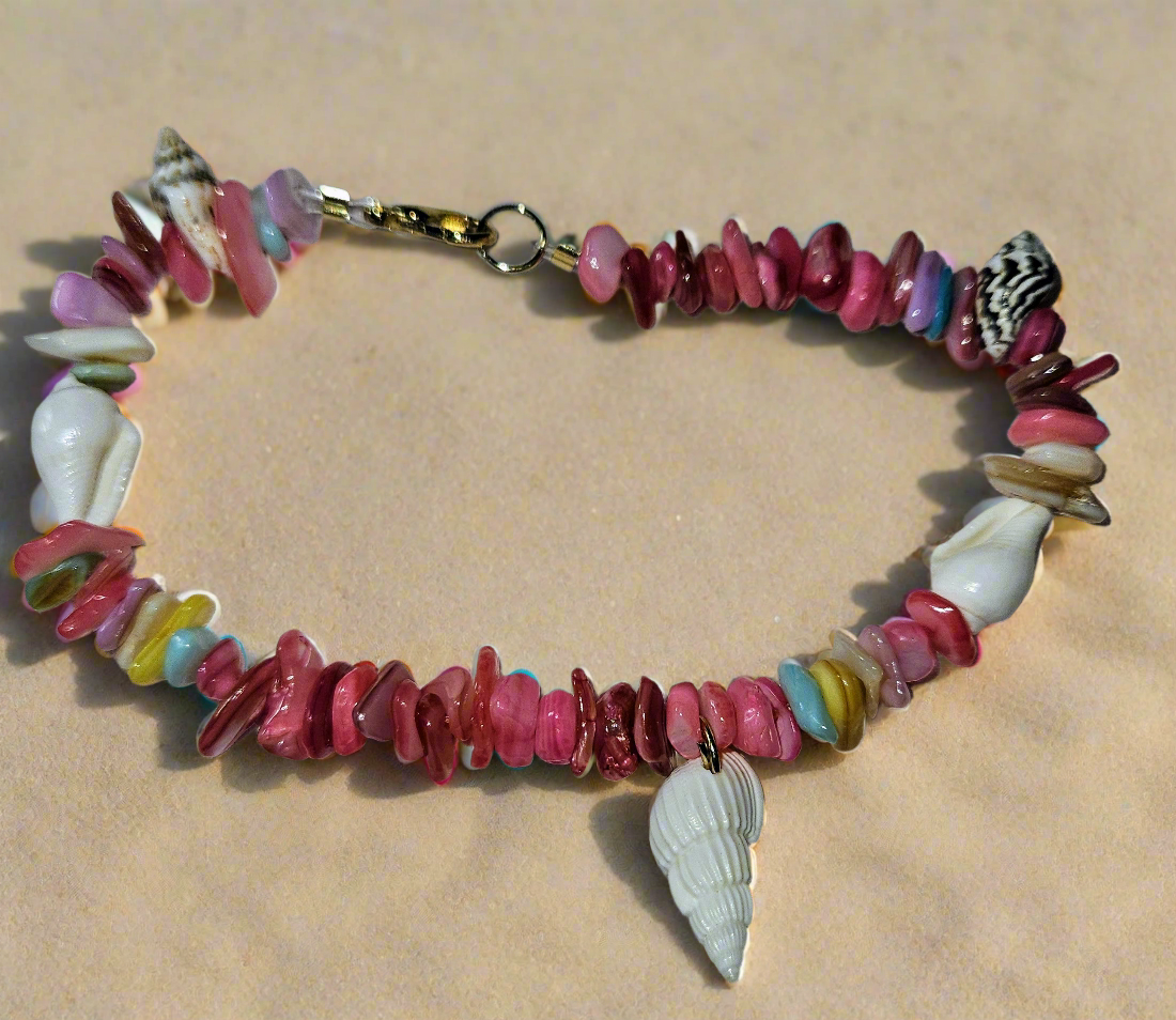 Colorful shell and bead necklace on a sandy background
